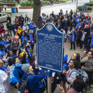 A photo from above the University of Florida African American Studies Historical Marker. Several people are standing around the historical marker celebrating the unveiling.