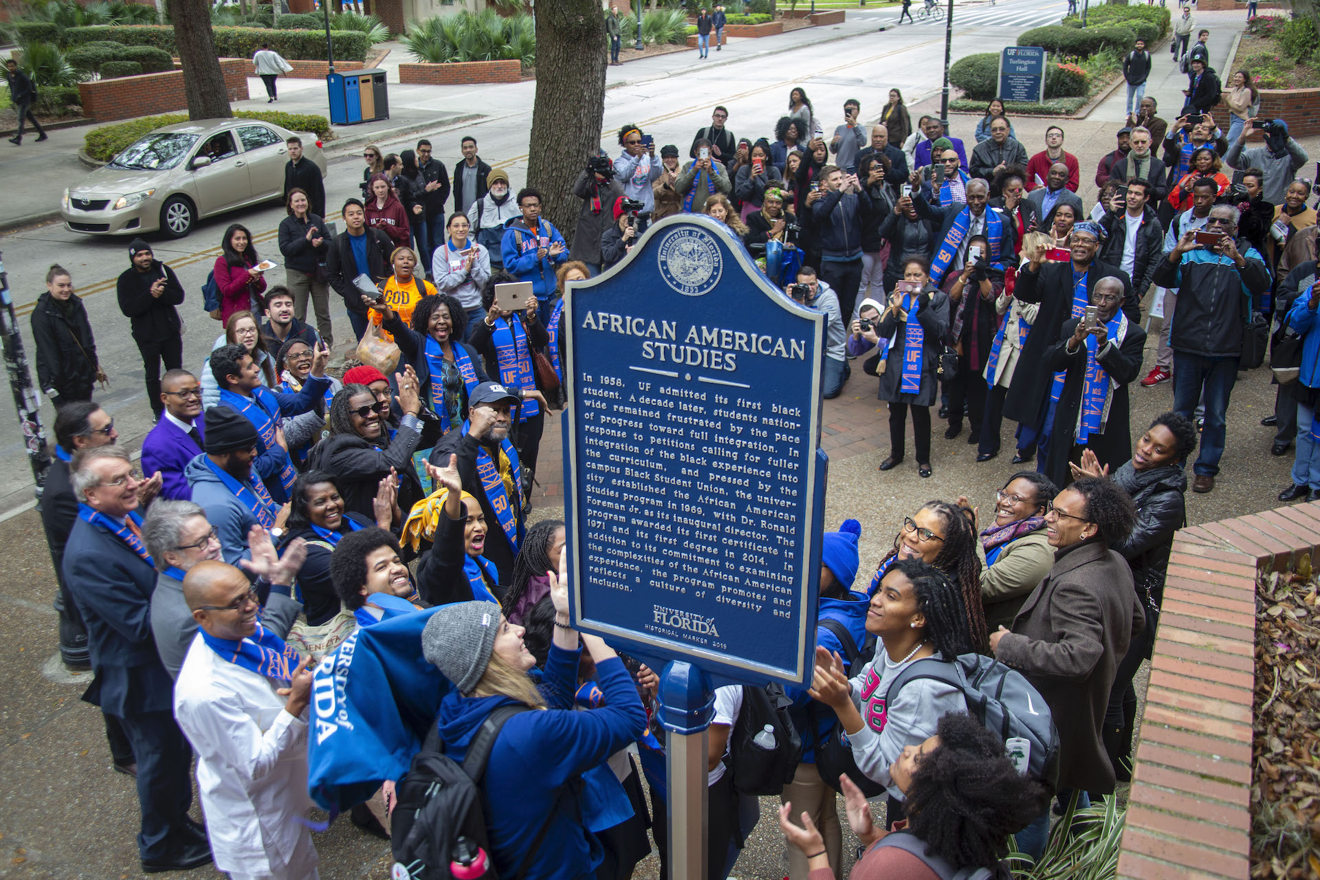 A photo from above the University of Florida African American Studies Historical Marker. Several people are standing around the historical marker celebrating the unveiling.