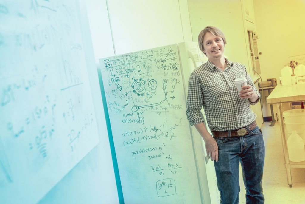 Tommy Angelini uses the refrigerator in his lab as a white board for quick calculations.