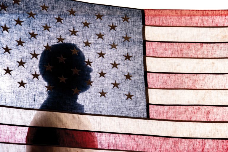 Juan Gilbert behind American flag