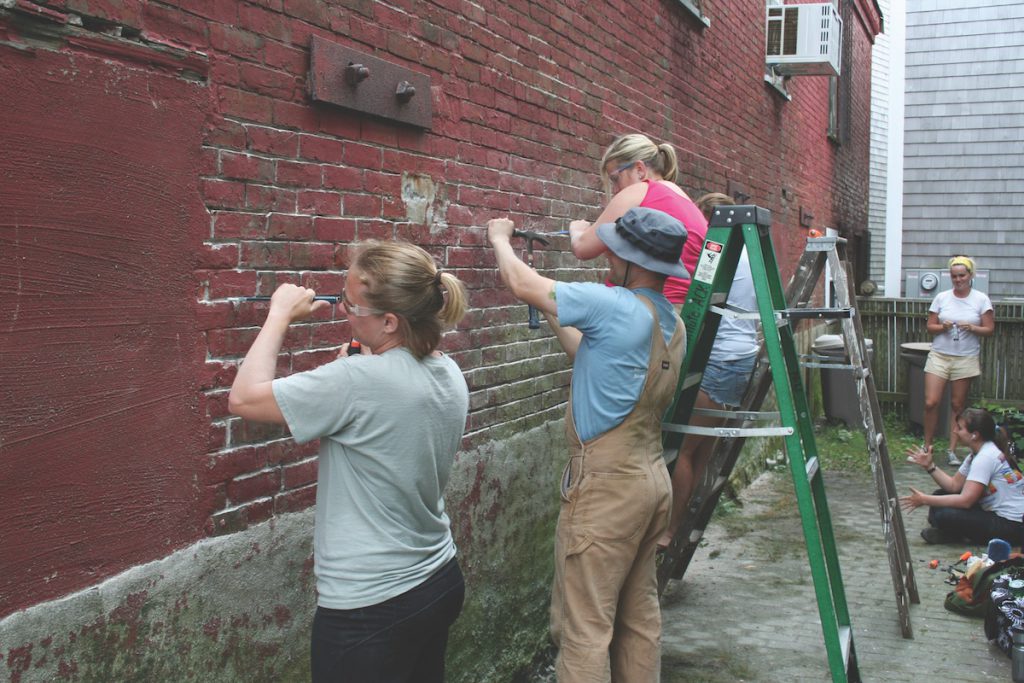 Students learn about the composition of building materials, such as mortar, so that homes can be restored authentically.