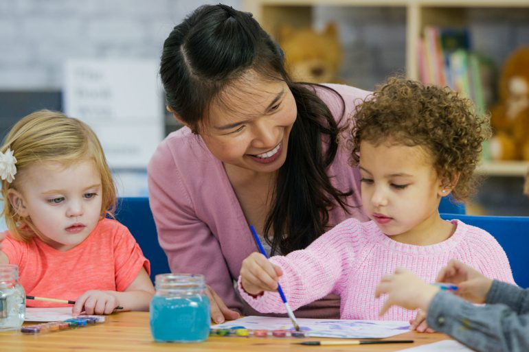 Teacher working with young children in classroom