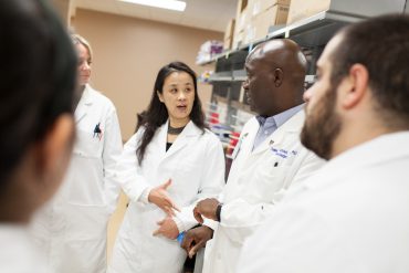 Dr. Jianping Huang (left center), Dr. Duane Mitchell (right center) and colleagues.