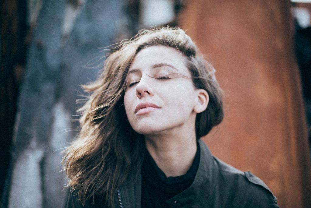 Woman inhaling with eyes closed