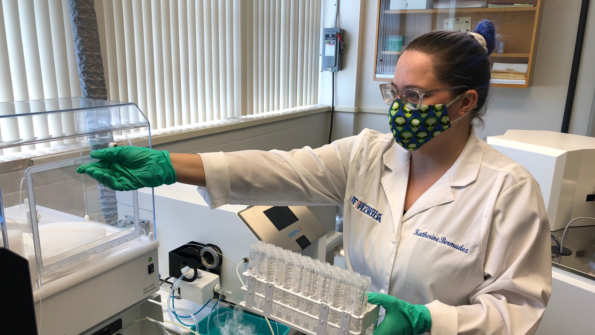 Katherine Bermudez conducts research in lab wearing PPE.