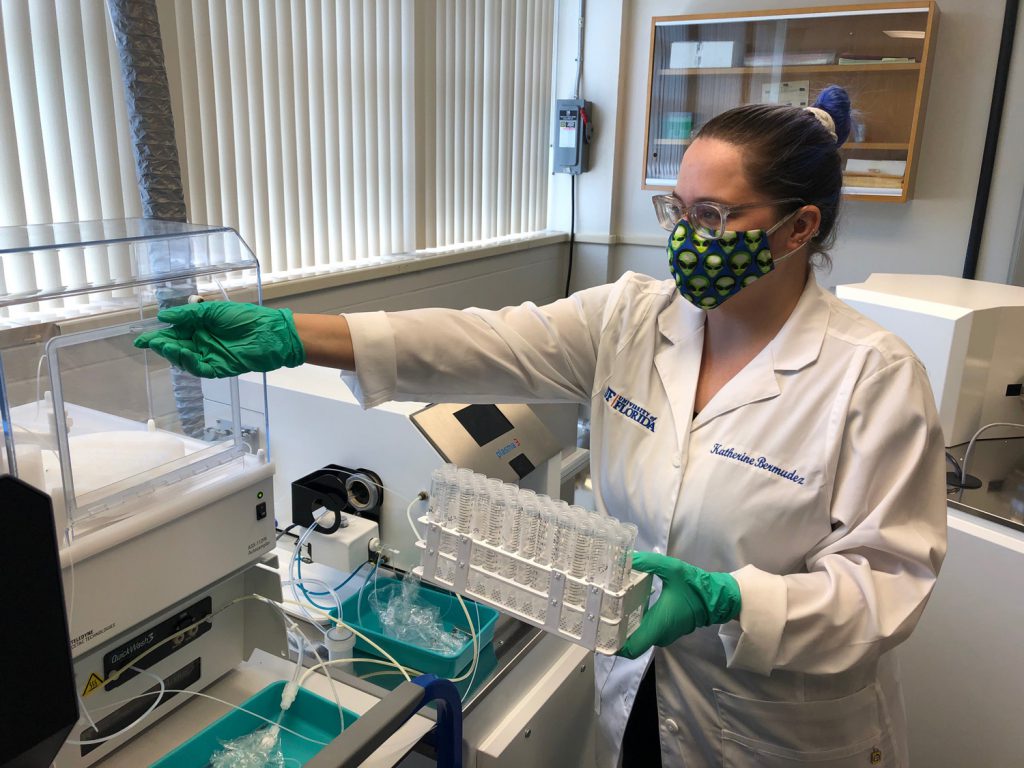 Kathering Bermudez wearing a mask while working in research lab.