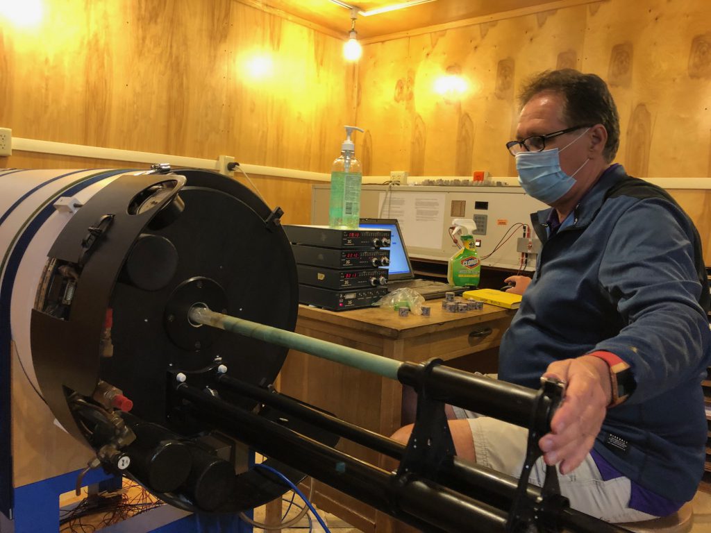 Joseph Meert wears mask while operating lab equipment.