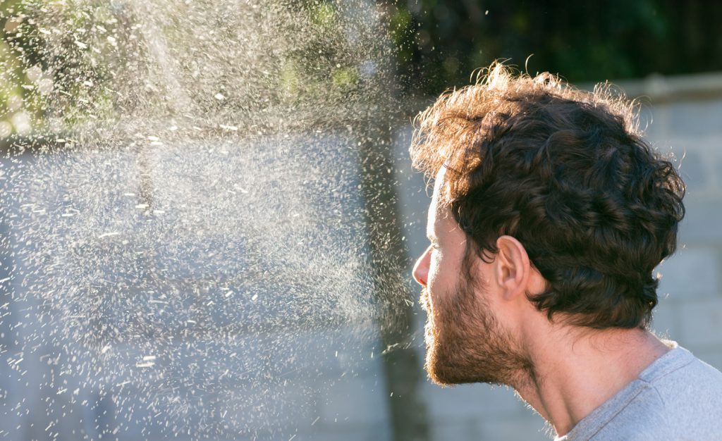 Puff of droplets and aerosols emitted from a sneeze.