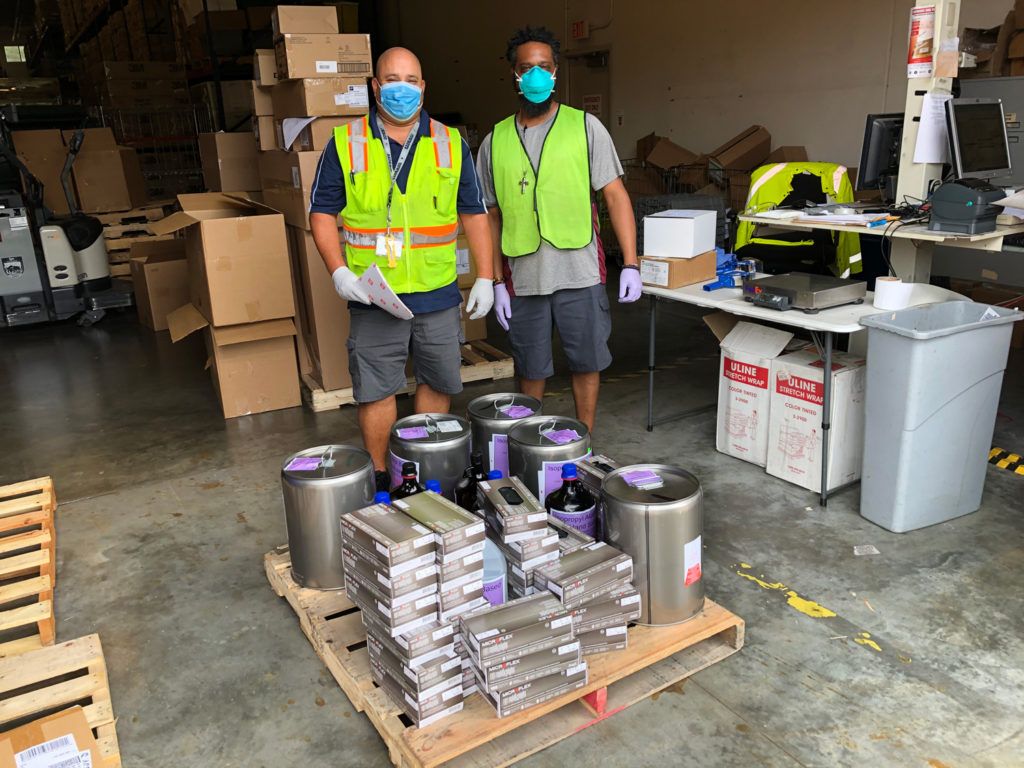 UF Health warehouse workers wearing PPE.