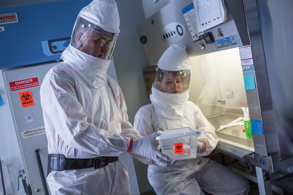 Dr. John Lednicky and lab manager Julia Gibson have strict protocols in their lab for managing viruses like the SARS-CoV-2 virus that causes COVID-19.