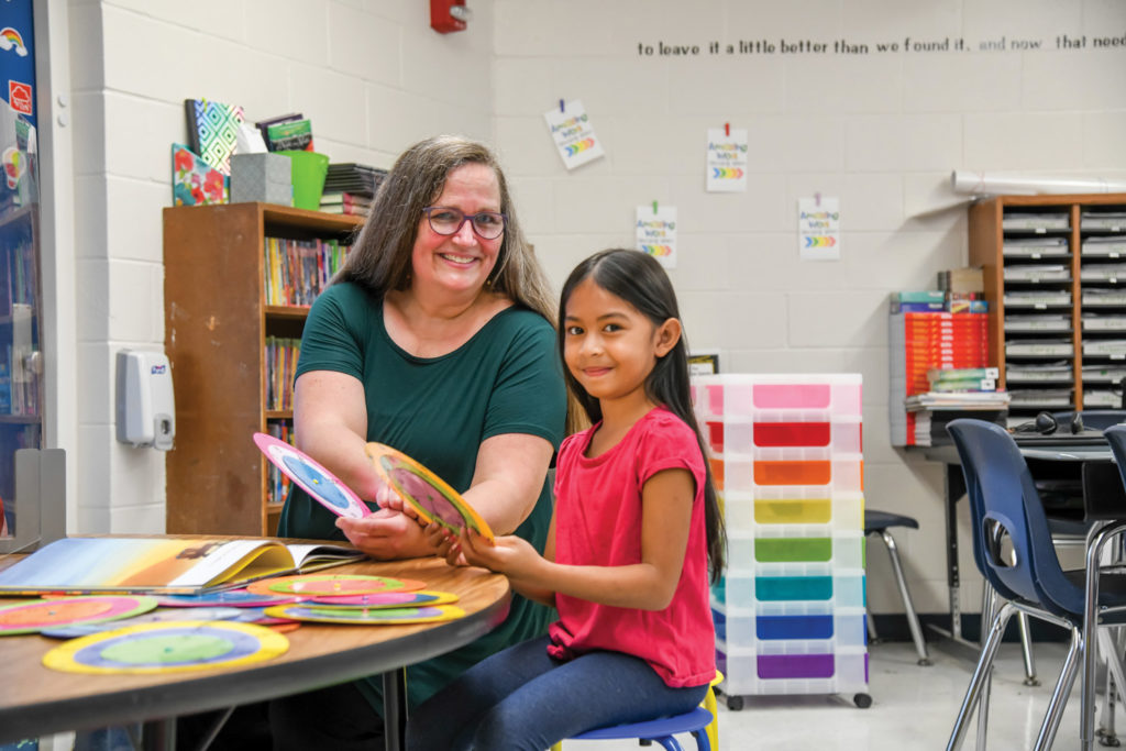 Shauna Quirk and student, Ayanna Hornilla, practice reading using the Flamingo Literay Matrix wheels