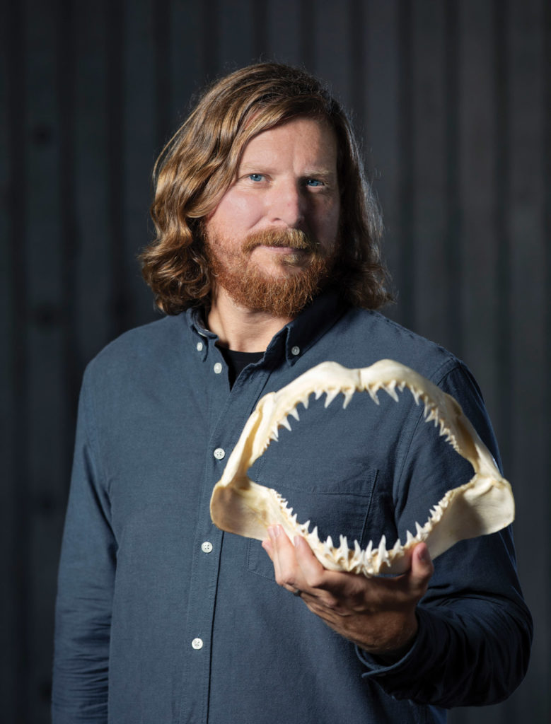 Portrait of Gareth Fraser holding a shark jaw