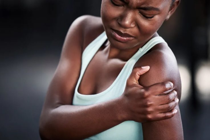Girl holding her arm in pain