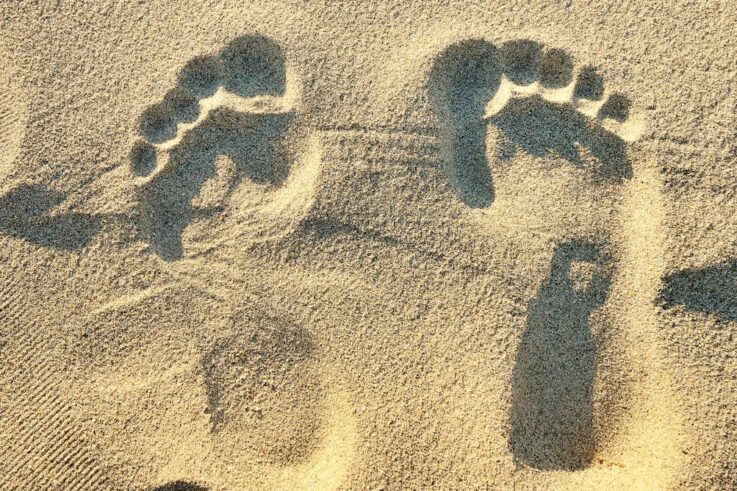 An image of footprints in the sand.