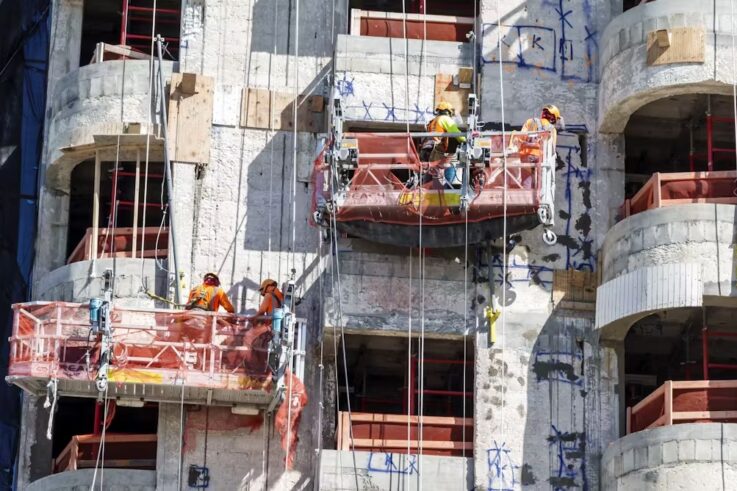 A photo of high-rise condos being built by construction workers in Miami Beach.